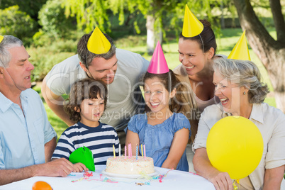 Extended family wearing party hats at birthday celebration in pa