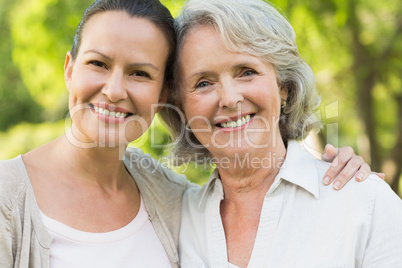 Close-up of smiling mature woman with daughter at park