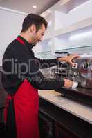 Smiling attractive barista making cup of coffee