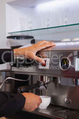 Barista making cup of hot coffee
