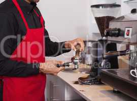 Barista pressing the coffee grounds