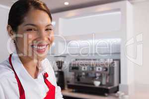 Pretty barista smiling at camera