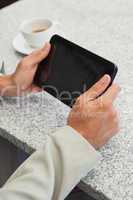 Businessman using a small tablet pc at table