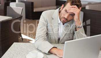 Stressed businessman working with his laptop