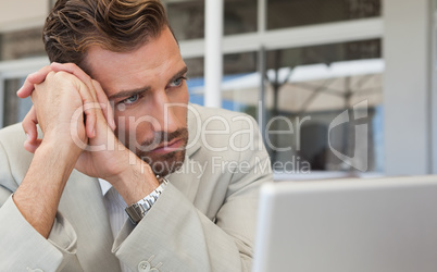 Frowning businessman looking away