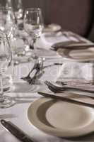 Table set for dinner service with white linen