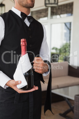 Waiter holding magnum of champagne