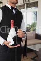 Waiter holding magnum of champagne