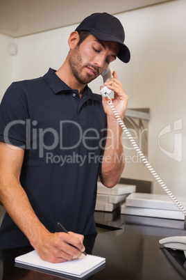 Pizza delivery man taking an order over the phone