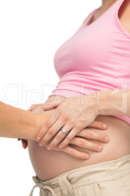 Expectant father touching mothers bump