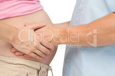 Expectant father touching mothers baby bump
