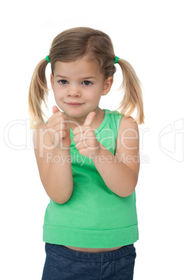 Cute little girl smiling at camera giving thumbs up