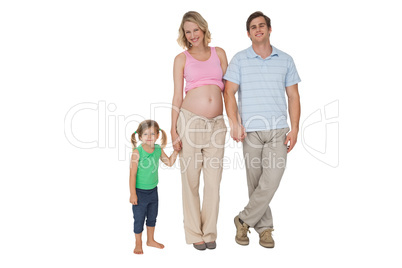 Happy family expecting a new arrival smiling at camera