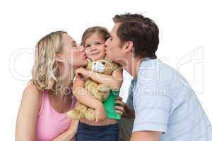 Parents kissing their little girl on her cheeks