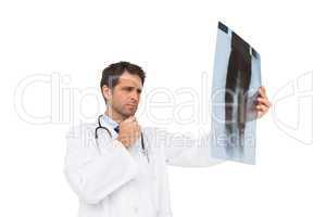 Focused doctor analysing xray