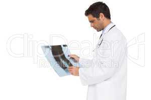 Serious doctor analysing xray