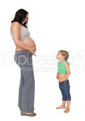 Little girl looking up at her mothers baby bump