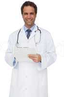 Handsome doctor smiling at camera holding clipboard
