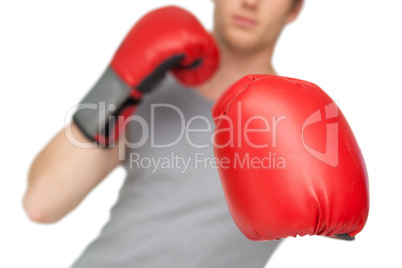 Athletic man wearing red boxing gloves