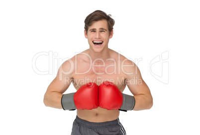 Fit man wearing red boxing gloves and shouting