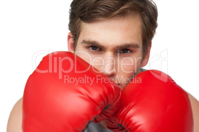 Fit man wearing red boxing gloves