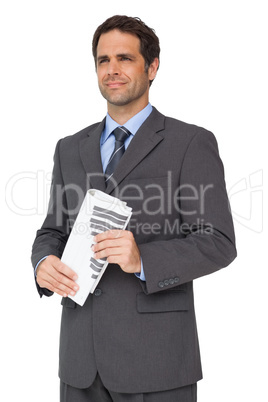 Handsome businessman holding a newspaper