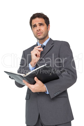 Handsome businessman holding his diary