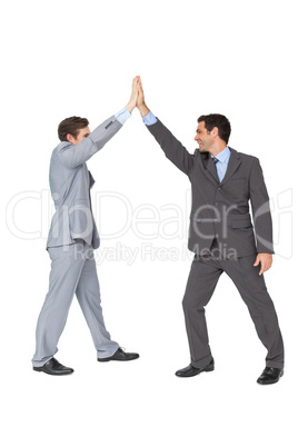 Unified business team high fiving each other