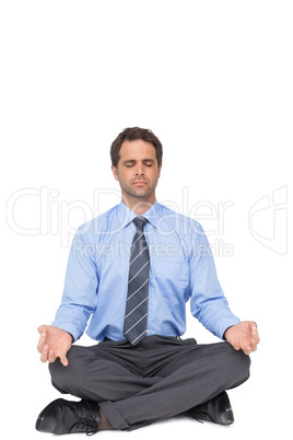 Zen businessman meditating in lotus pose