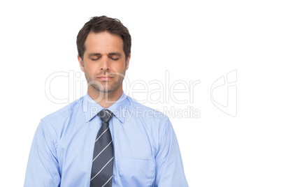 Zen businessman meditating with eyes closed