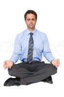 Zen businessman meditating in yoga pose