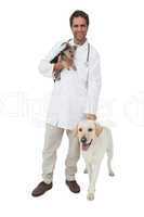 Happy vet smiling at camera with yorkshire terrier and yellow la