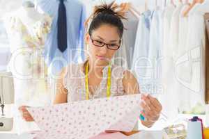 Concentrated female fashion designer at work