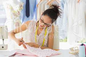 Concentrated fashion designer working on fabrics
