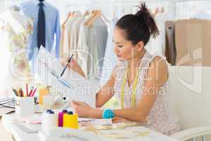 Female fashion designer working on her designs