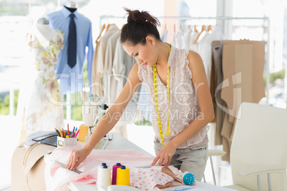 Female fashion designer working on fabrics