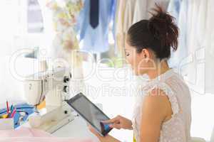 Female fashion designer using digital tablet