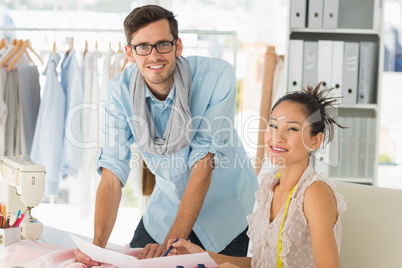 Fashion designers at work in bright studio