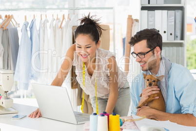 Fashion designers using laptop in studio