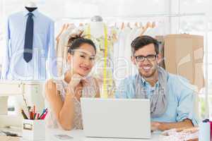 Fashion designers using laptop in studio