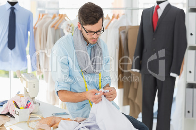 Concentrated male fashion designer at work