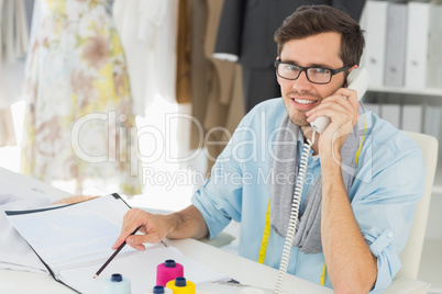 Smiling male fashion designer using phone