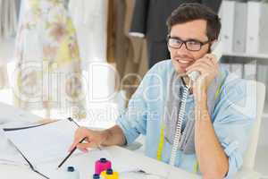 Smiling male fashion designer using phone