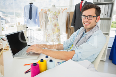 Male fashion designer using laptop