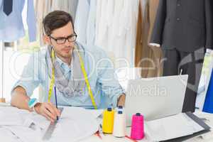 Male fashion designer working on his designs