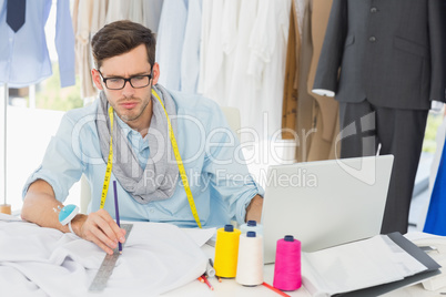 Male fashion designer working on his designs