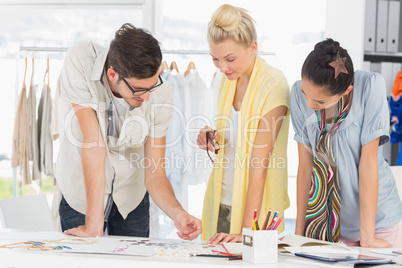 Fashion designers discussing designs