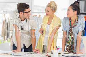 Fashion designers discussing designs