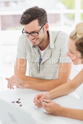 Smiling young man and woman working at desk