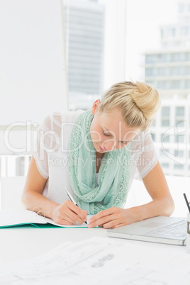 Casual young woman writing notes